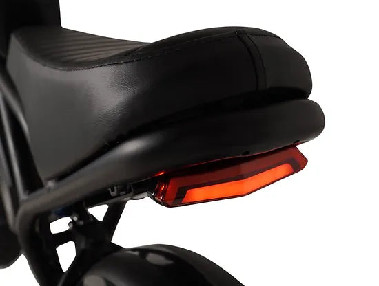 Saltebikes: Close-up of rear LED brake light beneath padded seat on the Mamba Kalahari e-bike for enhanced visibility and safety