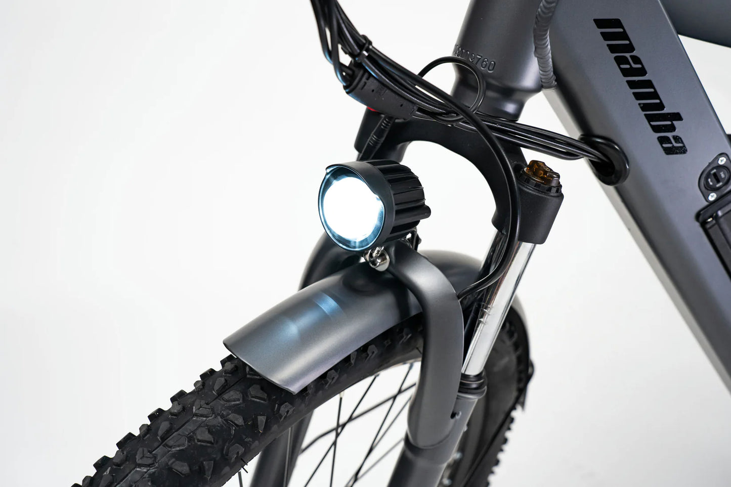 Mamba Venom 2024 e-bike LED headlight illuminated, ensuring visibility and safety on city and off-road rides, available at SalteBikes.