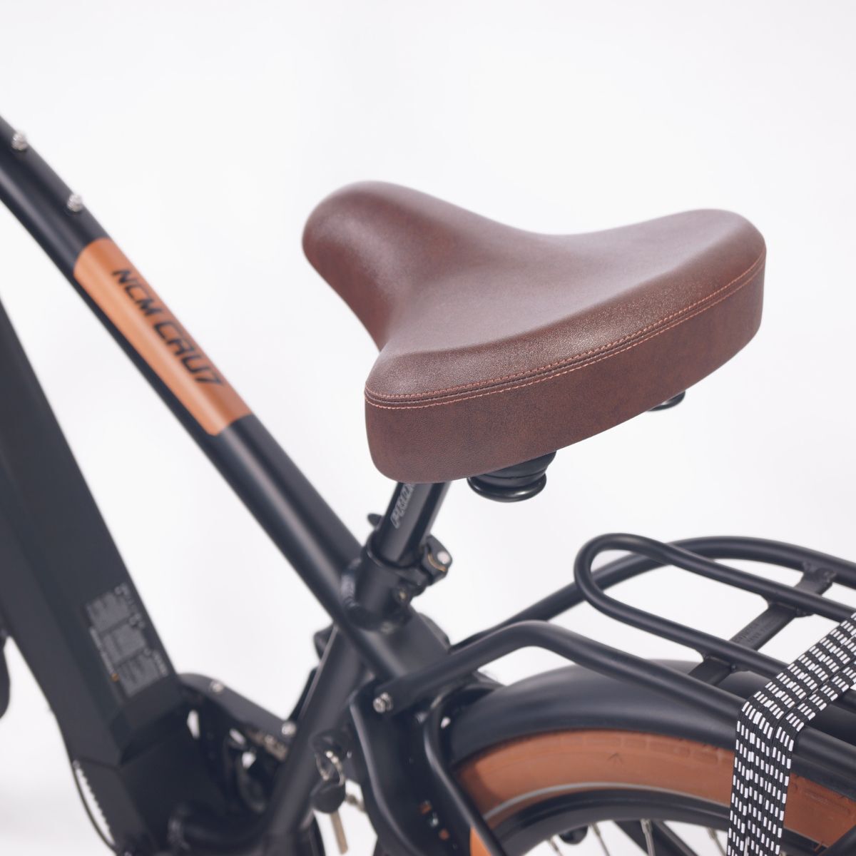 Close-up of the comfortable seat on NCM Cru7s Step-Through Cruiser E-Bike by SalteBikes, designed for a smooth and ergonomic ride